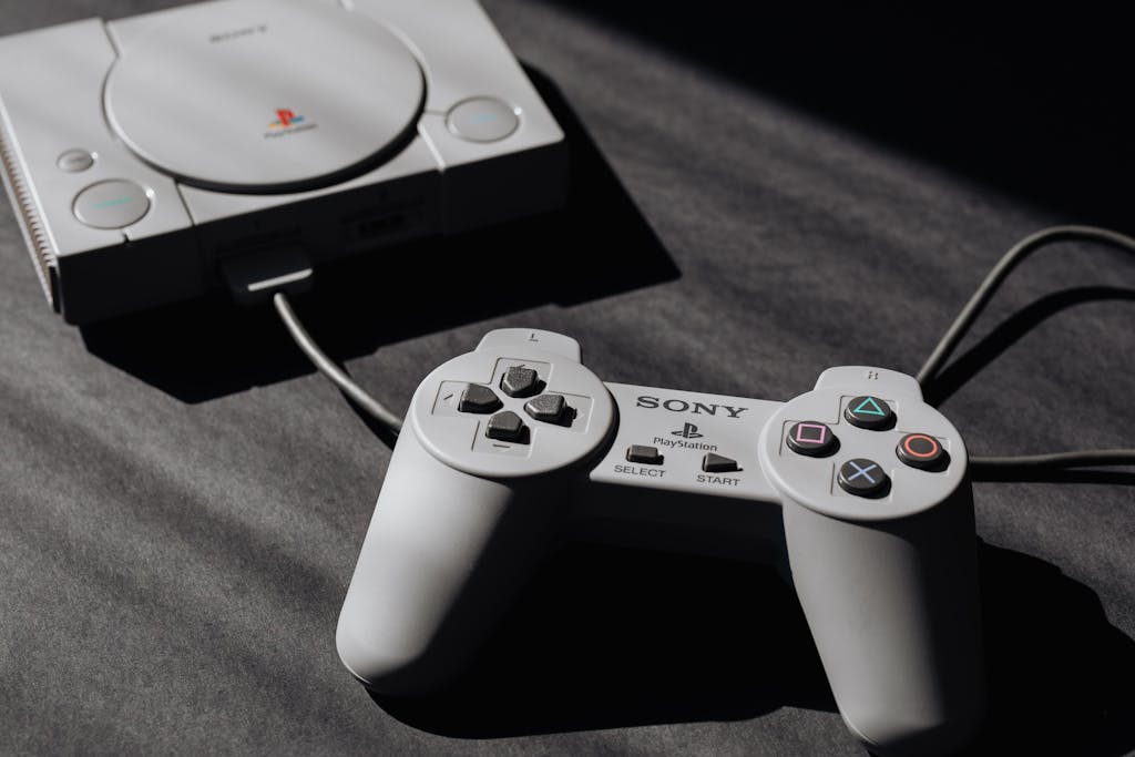 Retro Sony PlayStation console with classic controller, evoking nostalgic gaming memories.