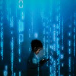 Silhouette of a person using a smartphone surrounded by digital binary code projections.